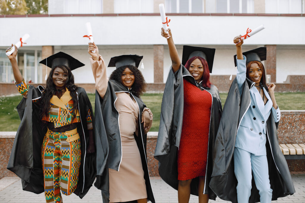 Excited african american female students at their graduation.